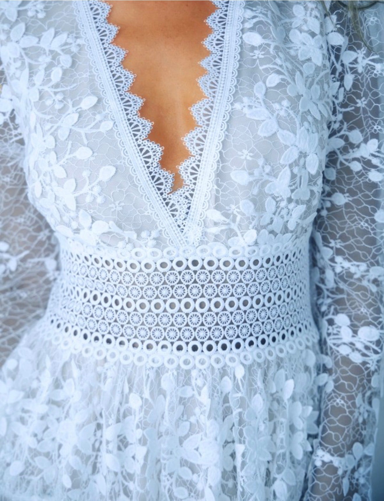 Close-up of powder blue lace dress with intricate detailing.